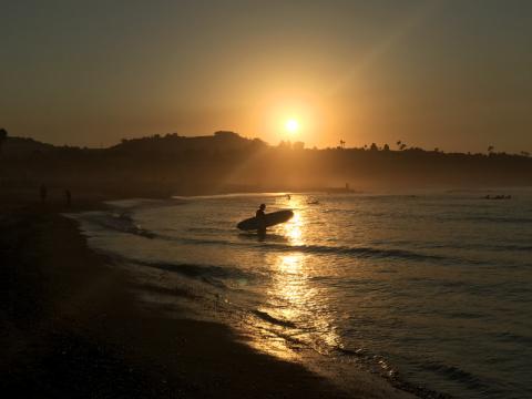 Sunrise Surfer on golden waves